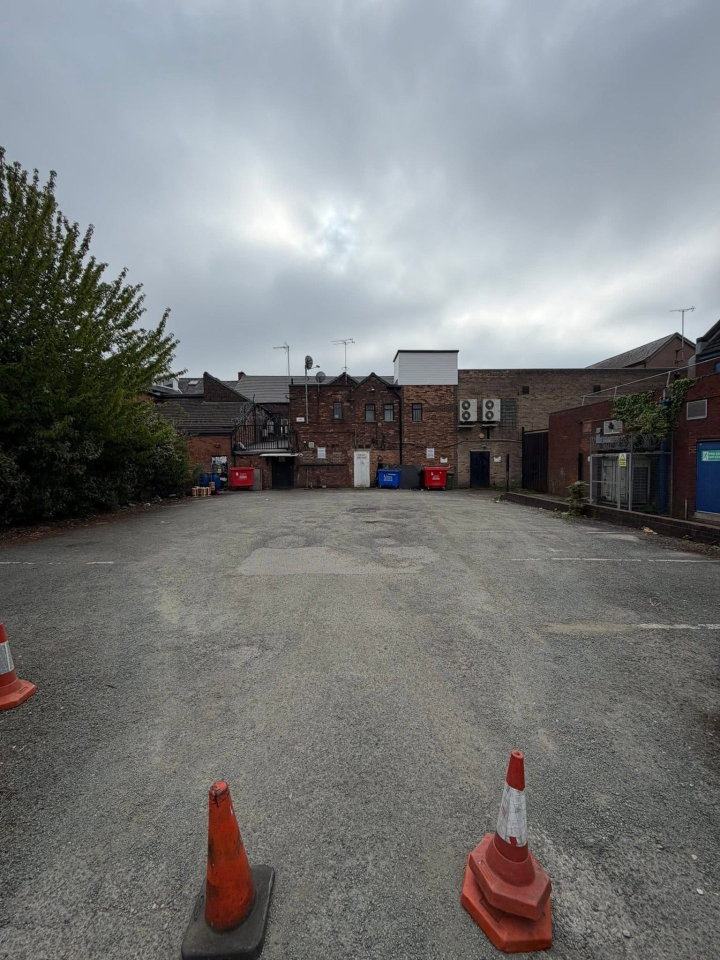 Wide commercial parking area and communal grounds