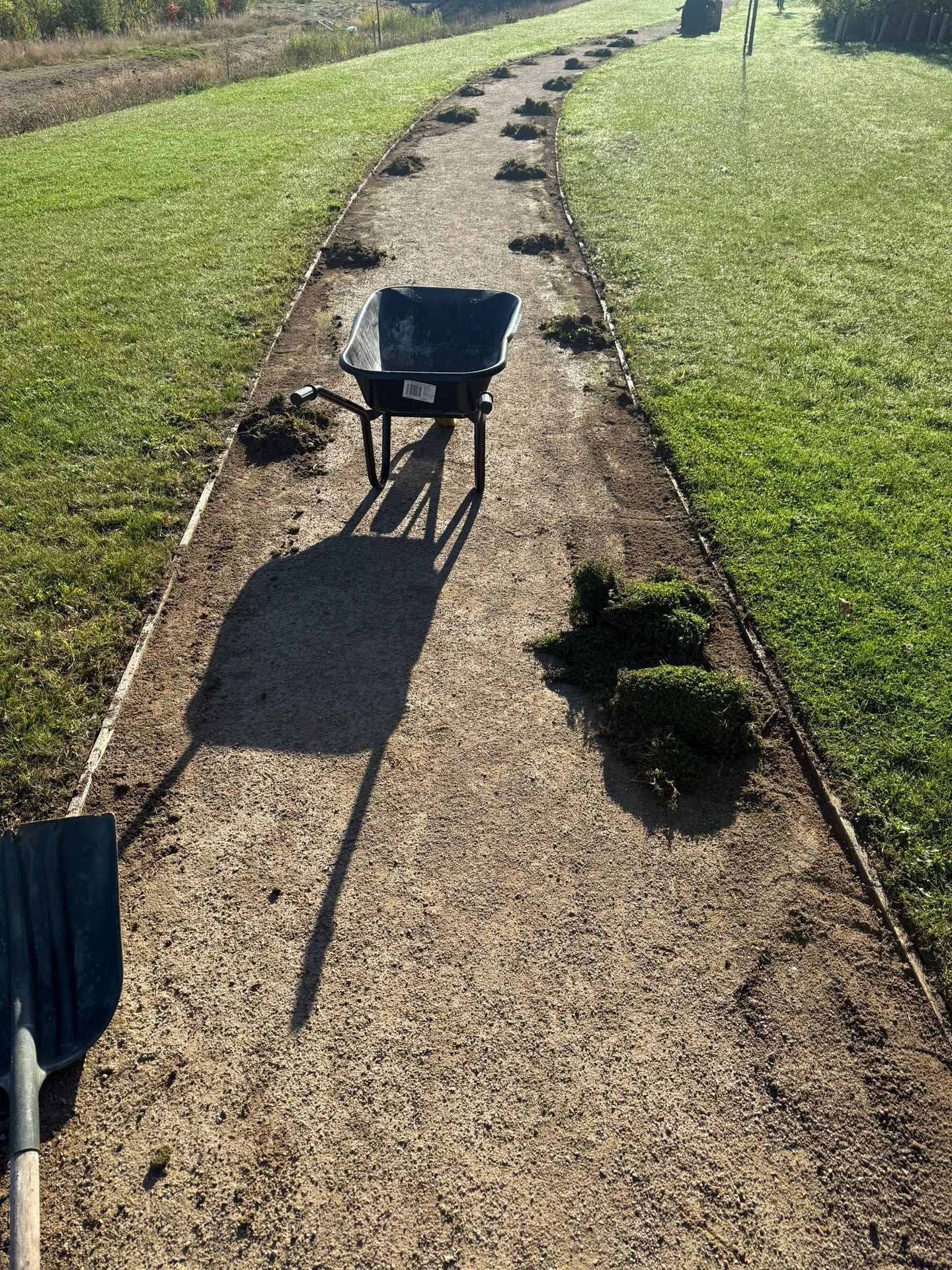 DMS cleaning and grounds maintenance team clearing a pathway during a site visit